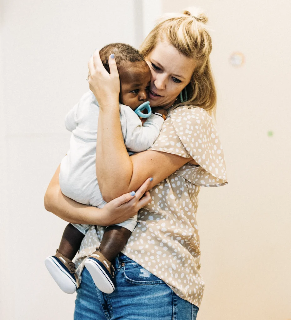Mother holding infant symbolizing God’s love, spiritual identity, and the calling to reflect Jesus through His power and presence.
